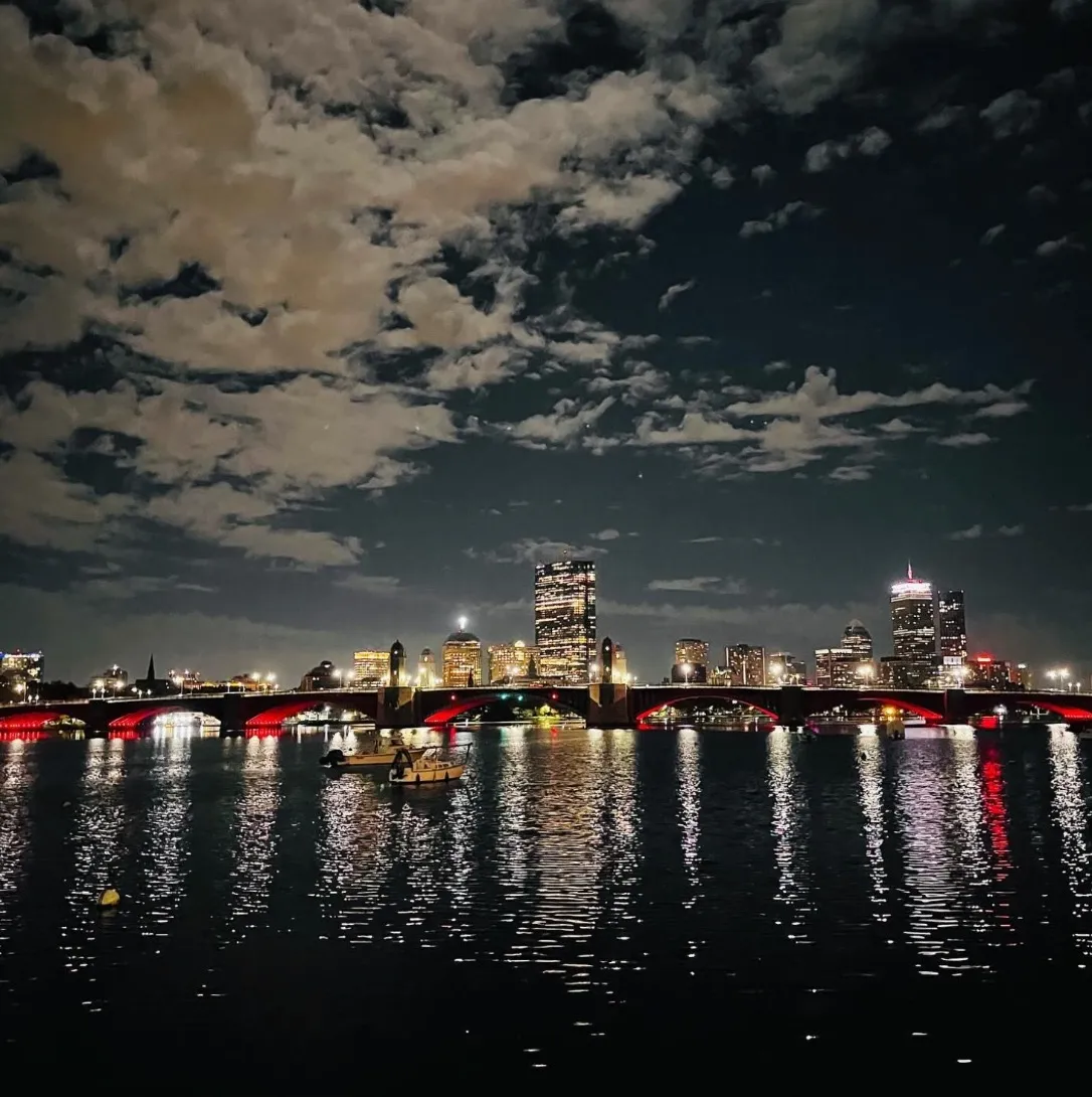 Boston skyline at night reflected in the Charles River