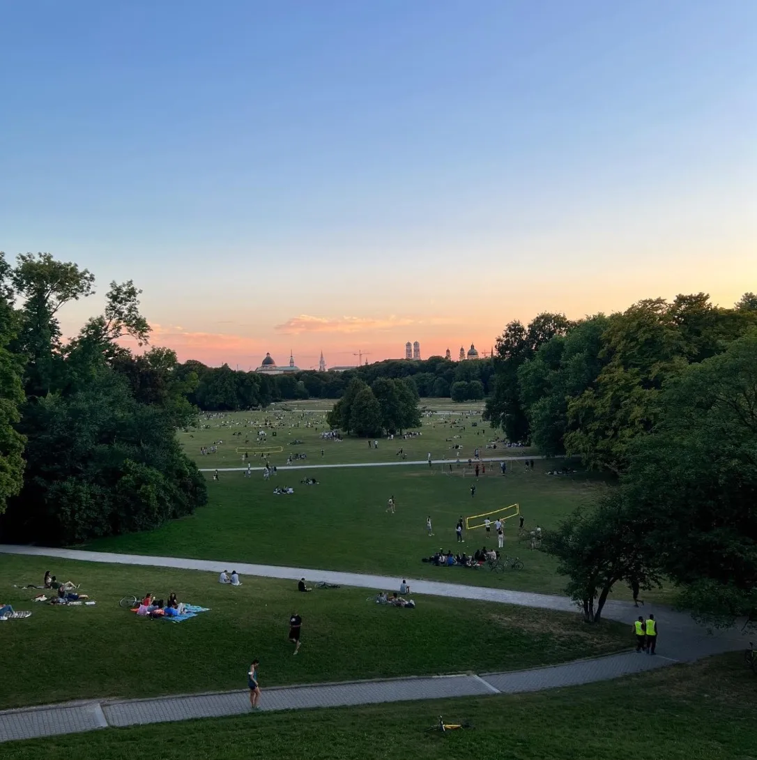 Englischer Garten at sunset with the city’s towers on the horizon