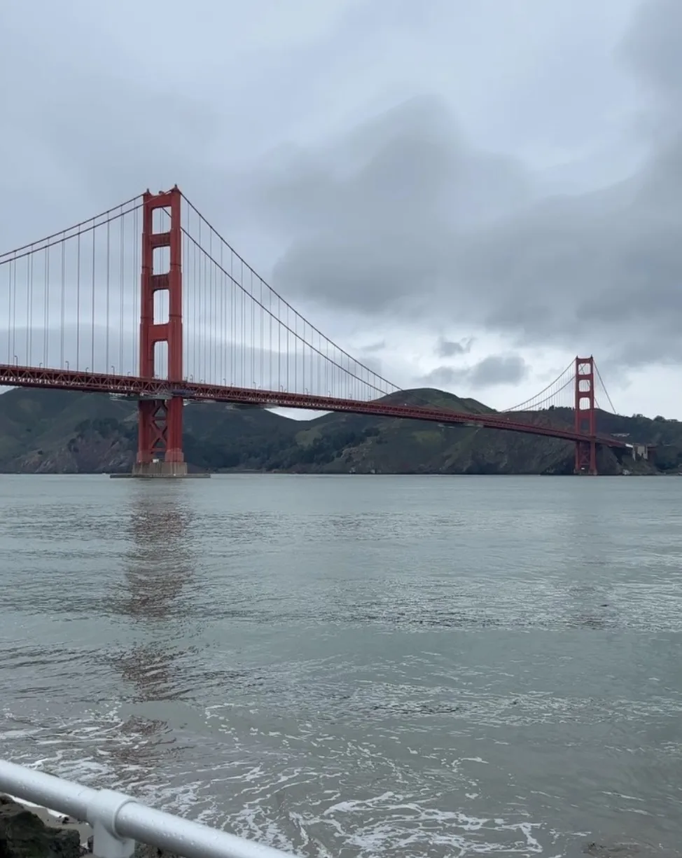 The Golden Gate Bridge on a grey day, seen from the water’s edge